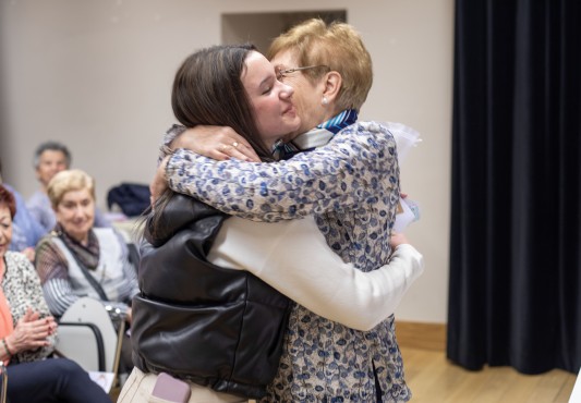 Abrazo entre una alumna y una participante de "Dame tu mano"